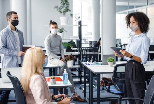 Employees in an office setting wearing masks.