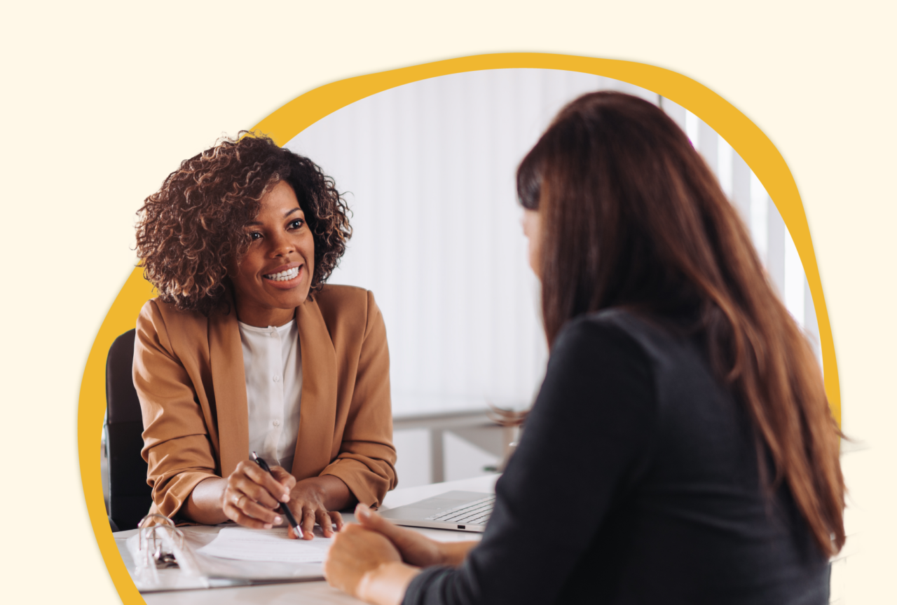 Two females having a meeting reviewing a paper together