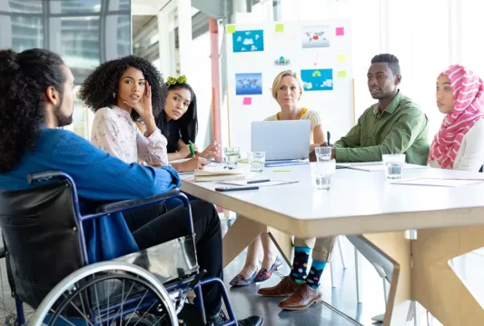 Diverse employees sitting around a table during a meeting